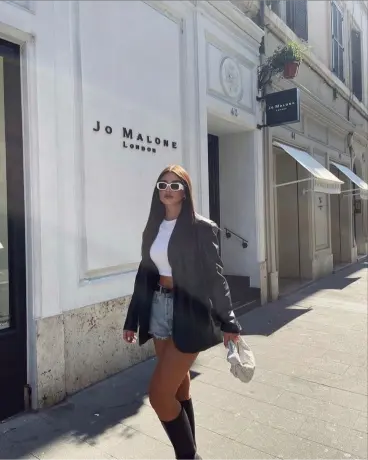Blazer negro con falda corta y botas