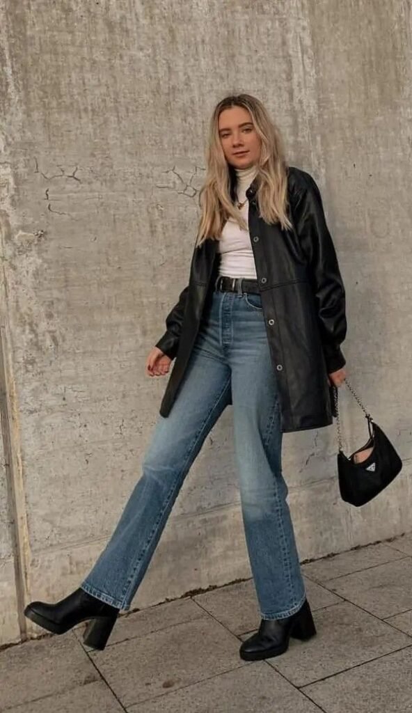 Chaqueta de cuero negra con top blanco y jeans rectos