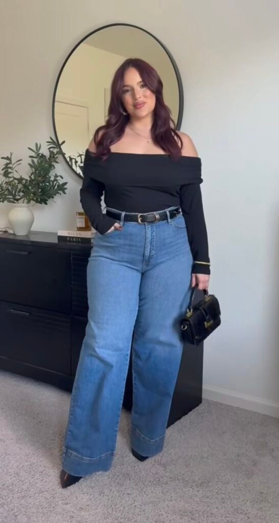 Top negro de hombros descubiertos con jeans anchos