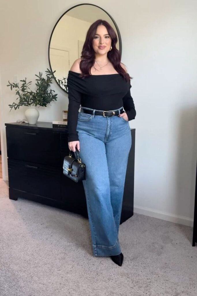 Top negro de hombros descubiertos con jeans anchos